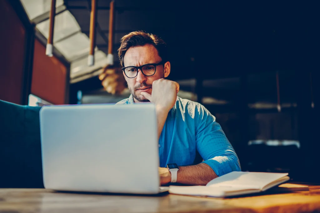 Man thinking in front of computer